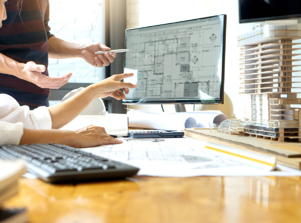 close up of hands pointing at a floorplan on screen